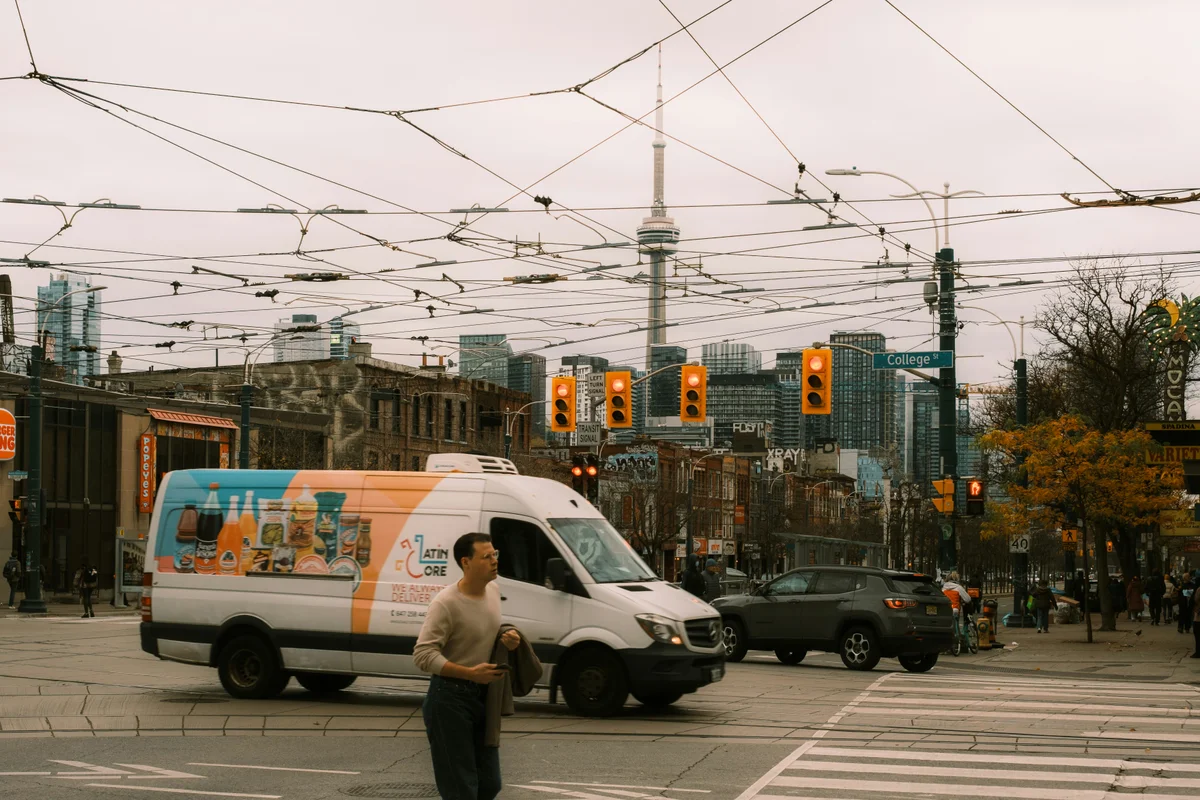 A white van drives through a city street.