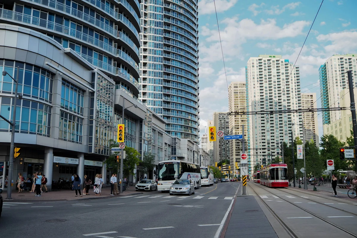 cars on road near high rise buildings during daytime