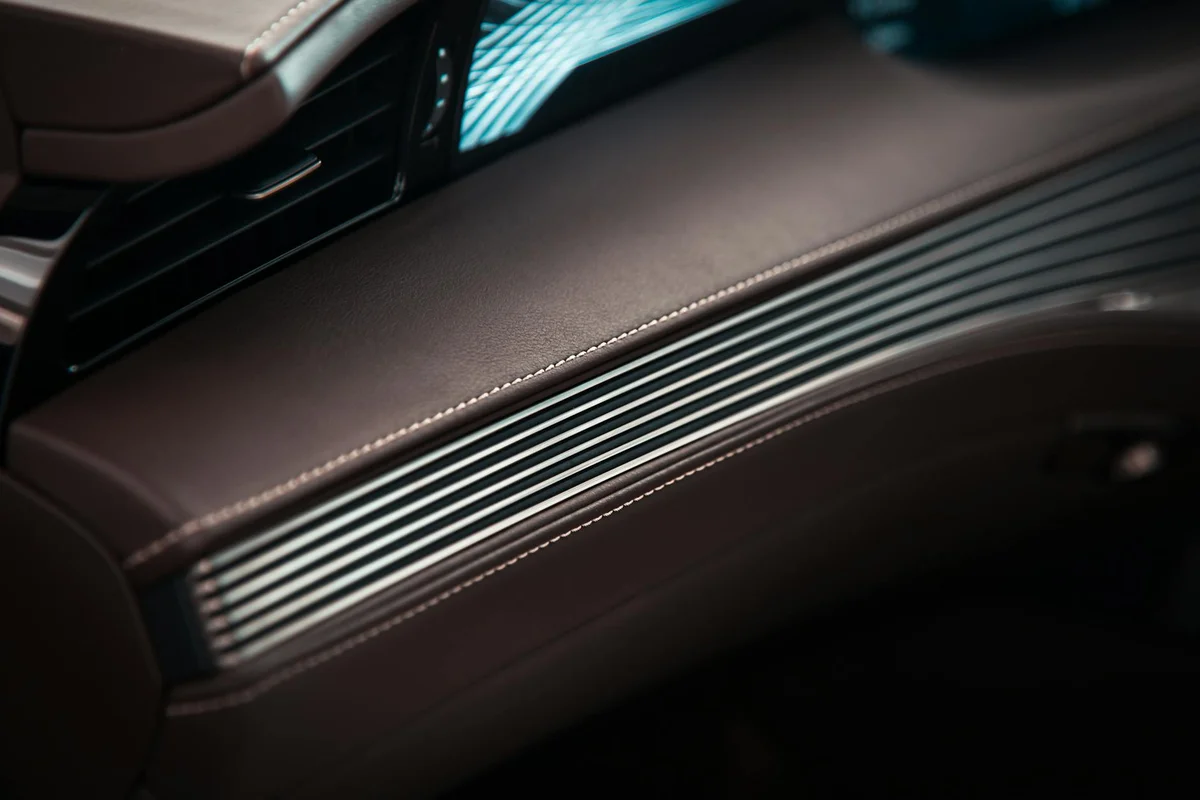 Detailed view of luxurious car interior with leather and metallic accents.