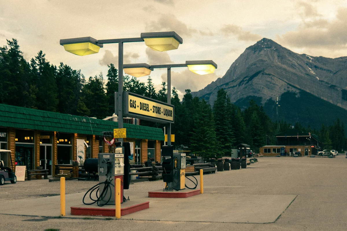 a gas station with mountains in the background
