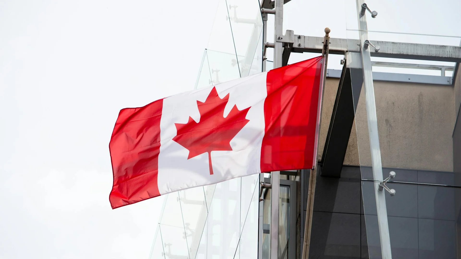 A vibrant Canadian flag waving on a clear day, representing patriotism and national pride.