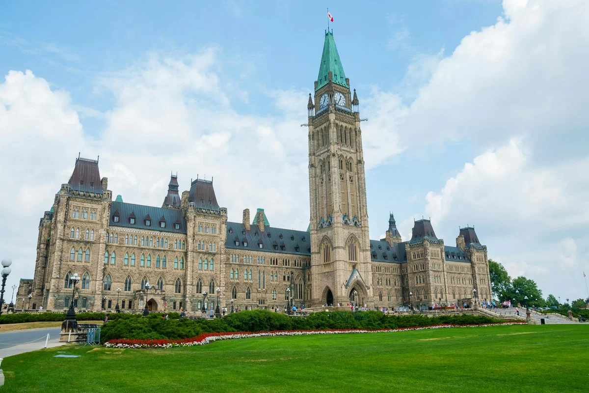 Stunning photo of Canada's Parliament Hill in Ottawa under a clear sky, showcasing Gothic Revival architecture.