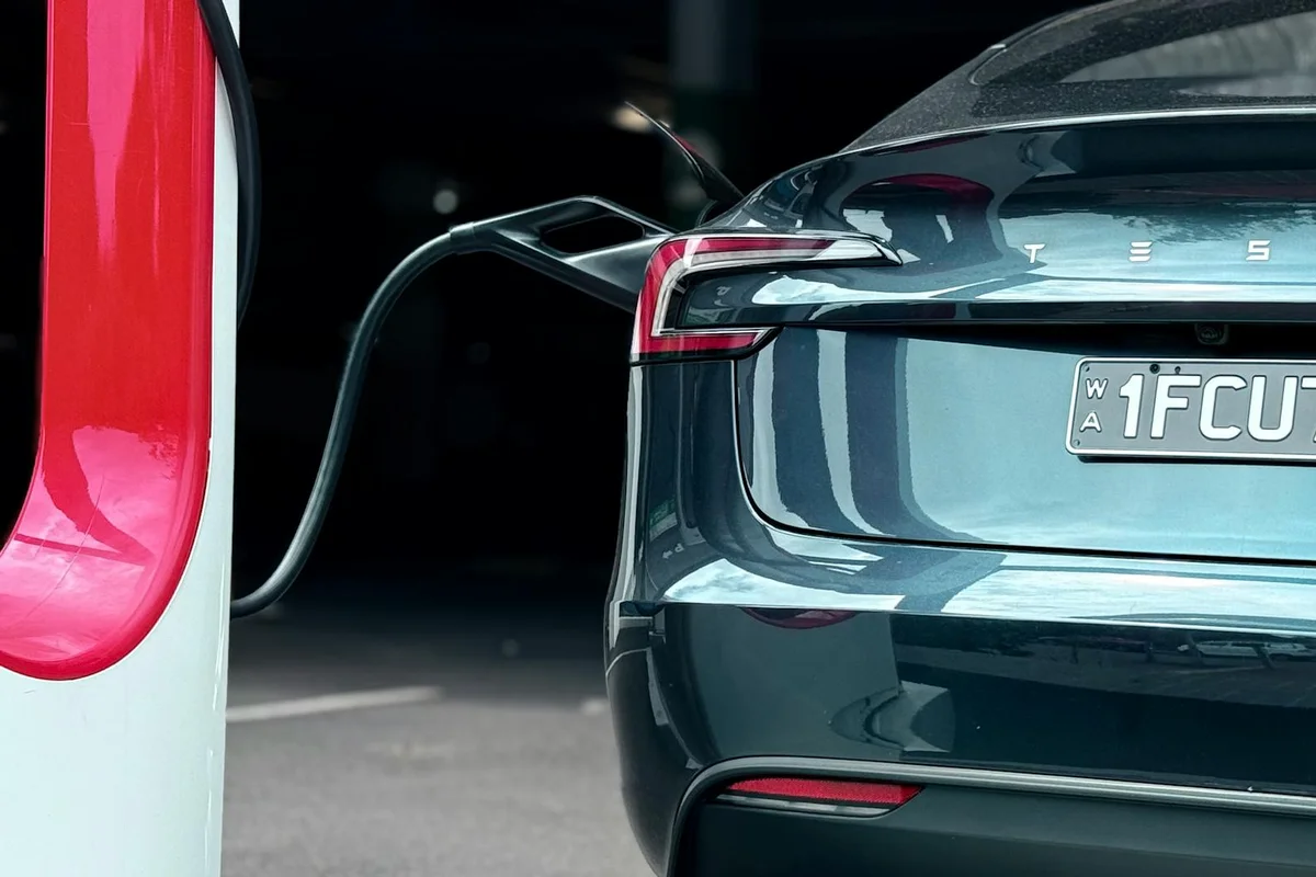 Close-up of an electric car charging at a station, showcasing modern sustainability.