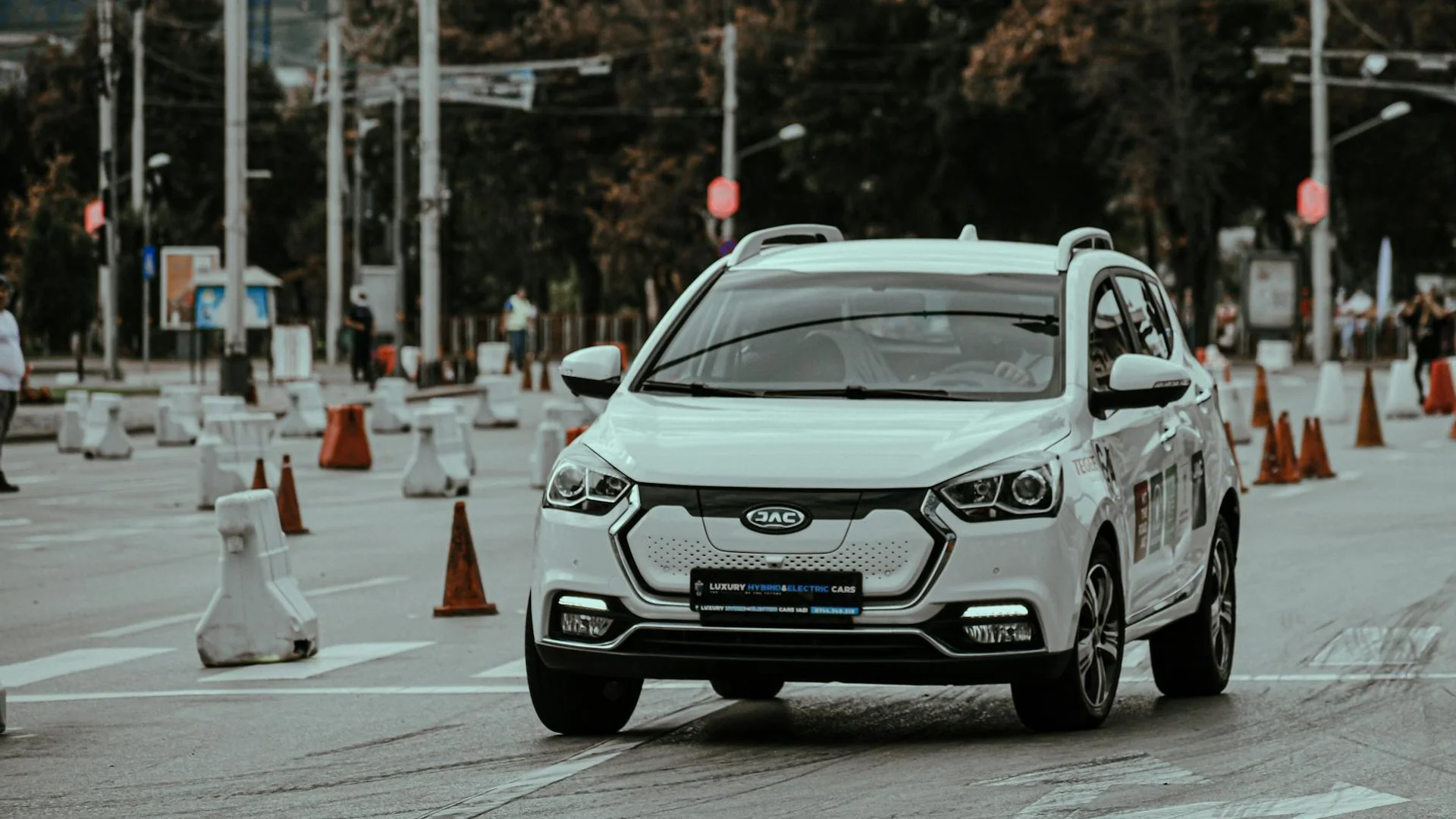 White car racing during urban rally and driving down paved street in daylight