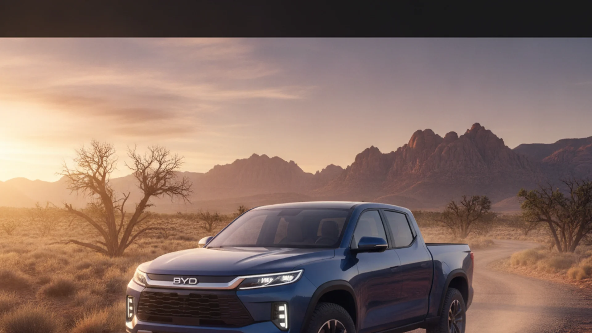 A blue BYD pickup truck drives on a dirt road through a desert landscape with mountains in the background.