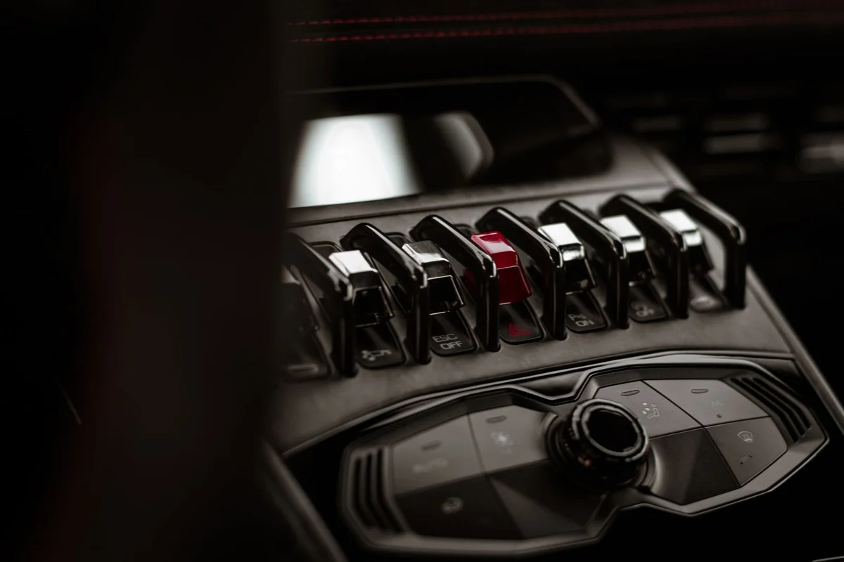 High-quality close-up of the Lamborghini Huracan dashboard showcasing switches and controls.