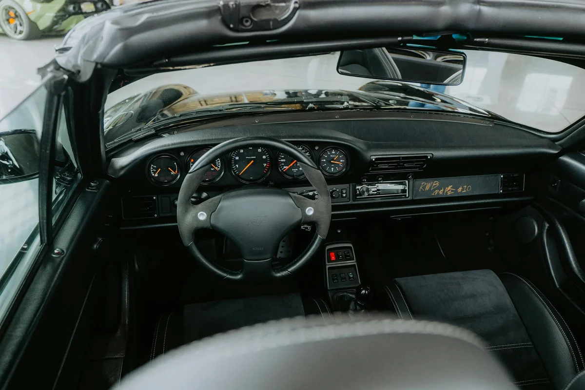 See the dashboard and interior of a classic convertible sports car with a sleek design and detailed dashboard.
