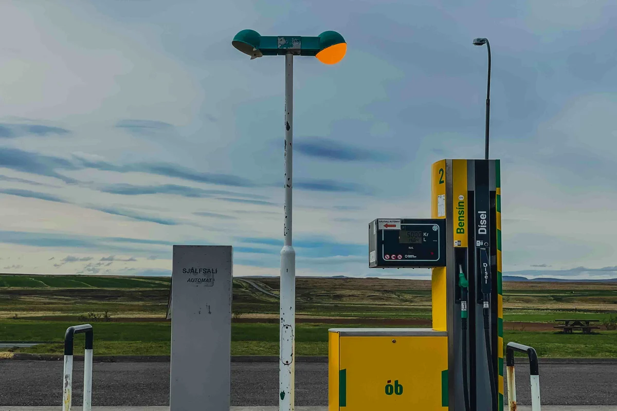 a gas station with a yellow and green gas pump