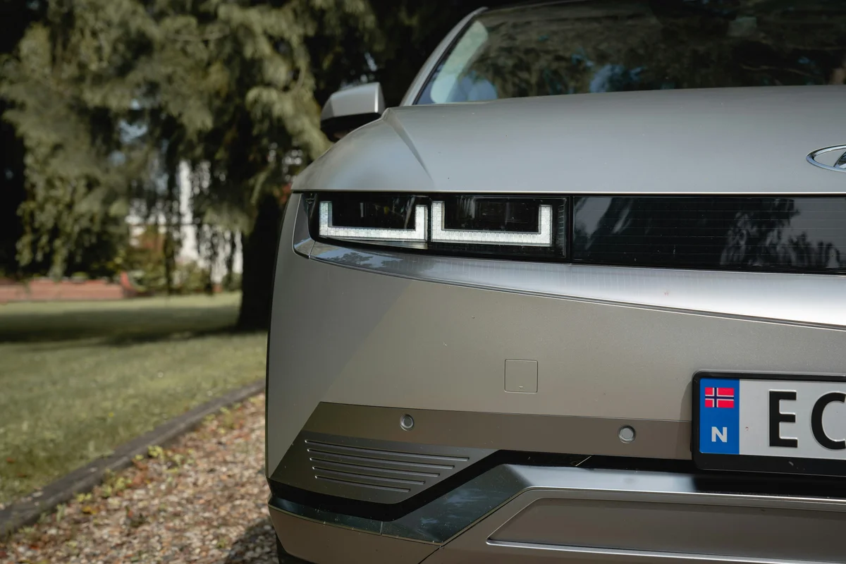 Close-up of a modern silver electric car's front