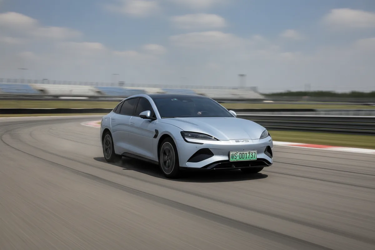 A BYD electric performance sedan on a racetrack
