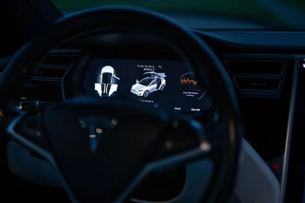 Close-up of a Tesla Model X dashboard display, showcasing advanced technology features.