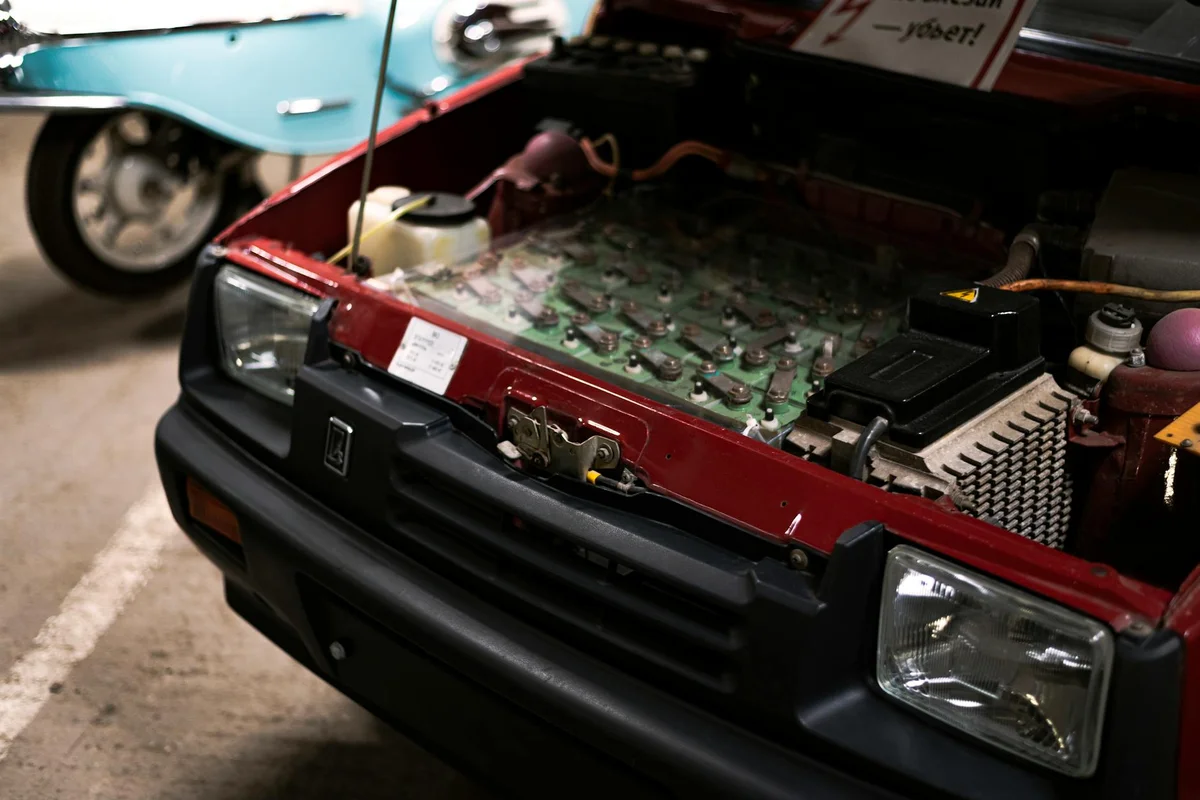 Detailed close-up of a car engine under the hood showcasing various components and connections.