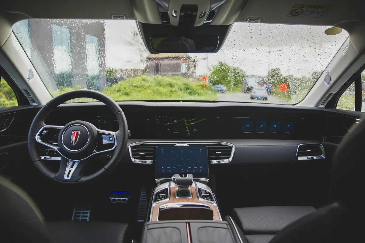 the inside of a car with a steering wheel and dashboard